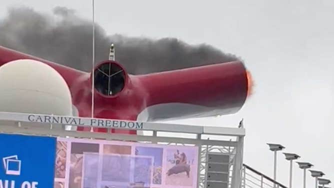 Smoke and flames coming from the exhaust tunnel of the Carnival Freedom cruise ship on Saturday, March 23, 2024. 