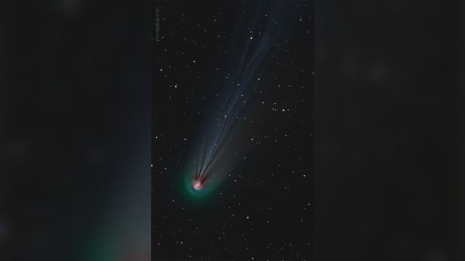 The featured image is a composite of three very specific colors, showing the comet's ever-changing ion tail in light blue, its outer coma in green, and highlights some red-glowing gas around the coma in a spiral. The spiral is thought to be caused by gas being expelled by the slowly rotating nucleus of the giant iceberg comet