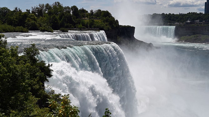 TOPSHOT - A general view shows water flowing over Niagara Falls in Niagara Falls, New York, on August 13, 2022.