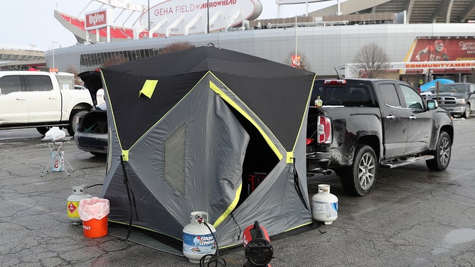 Kansas City Chiefs fans use tents and heaters to stay warm while tailgating in the brutal cold before an AFC Wild Card playoff game between the Miami Dolphins and Kansas City Chiefs on Jan 13, 2024 at GEHA Field at Arrowhead Stadium in Kansas City, Missouri.