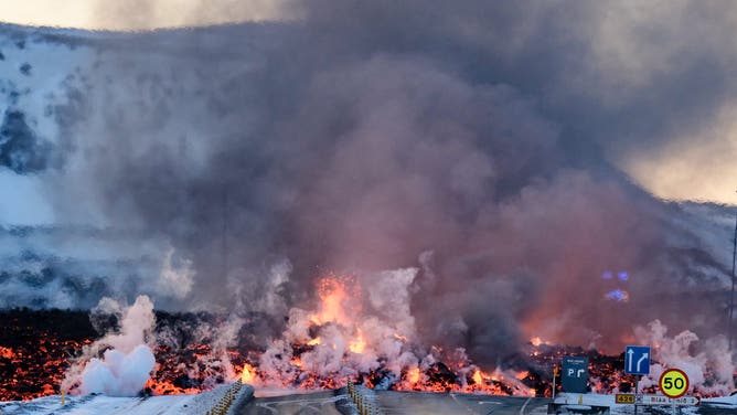 FILE - Molten lava is seen overflowing the road leading to the famous tourist destination "Blue Lagoon" near Grindavik, western Iceland on February 8, 2023. A volcanic eruption started on the Reykjanes peninsula in southwestern Iceland on Thursday, the third to hit the area since December, authorities said. (Photo by Kristinn Magnusson / AFP) / Iceland OUT (Photo by KRISTINN MAGNUSSON/AFP via Getty Images)