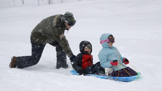 TRUCKEE, CALIFORNIA - FEBRUARY 29: A grandad pushes his grandchildren, from Oakland, at Northstar California Resort in Truckee, Calif., on Friday, March 1, 2024. (Jane Tyska/Digital First Media/East Bay Times via Getty Images)