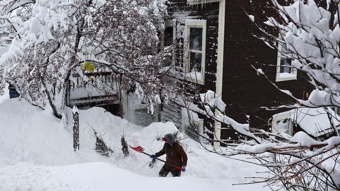 TRUCKEE, CALIFORNIA - MARCH 02: A worker digs out snow from a home north of Lake Tahoe during a powerful multiple day winter storm in the Sierra Nevada mountains on March 02, 2024 in Truckee, California. Blizzard warnings were issued with snowfall of up to 12 feet and wind gusts over 100 mph expected in some higher elevation locations. Yosemite National Park is closed and a 50-mile stretch of Interstate 80 was shut down yesterday due to the storm. (Photo by Mario Tama/Getty Images)
