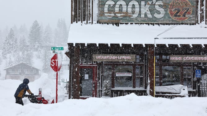 TRUCKEE, CALIFORNIA - MARCH 02: A worker uses a snowblower in front of a downtown business north of Lake Tahoe during a powerful multiple day winter storm in the Sierra Nevada mountains on March 02, 2024 in Truckee, California. Blizzard warnings were issued with snowfall of up to 12 feet and wind gusts over 100 mph expected in some higher elevation locations. Yosemite National Park is closed and a 50-mile stretch of Interstate 80 was shut down yesterday due to the storm. (Photo by Mario Tama/Getty Images)
