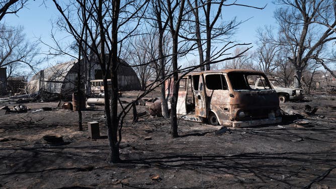 Charred remains of vehicles sit behind a shop that was destroyed by the Smokehouse Creek fire when it burned its way through town last Tuesday on March 02, 2024 in Stinnett, Texas.