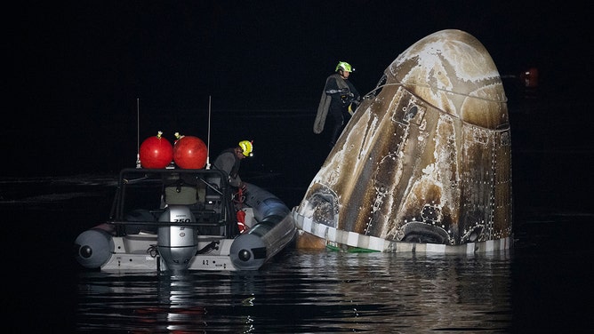 In this handout provided by the National Aeronautics and Space Administration (NASA), Support teams work around the SpaceX Dragon Endurance spacecraft shortly after it landed in the Gulf of Mexico off the coast of Pensacola, Florida, Tuesday, March 12,2024.