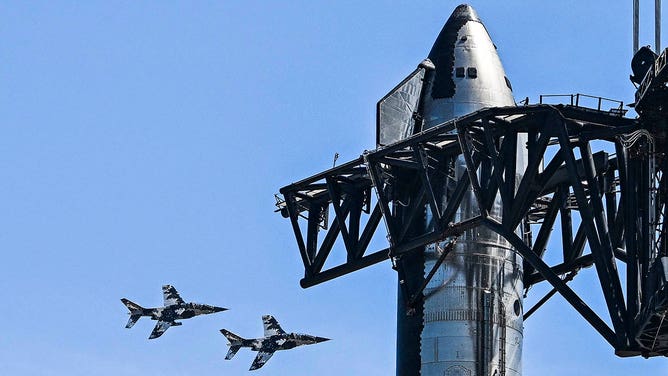 US billionaire businessman and pilot Jared Isaacman flies in formation aboard a fighter jet over the SpaceX Starship spacecraft, before his third test flight from Starbase in Boca Chica, Texas, on March 13, 2024.