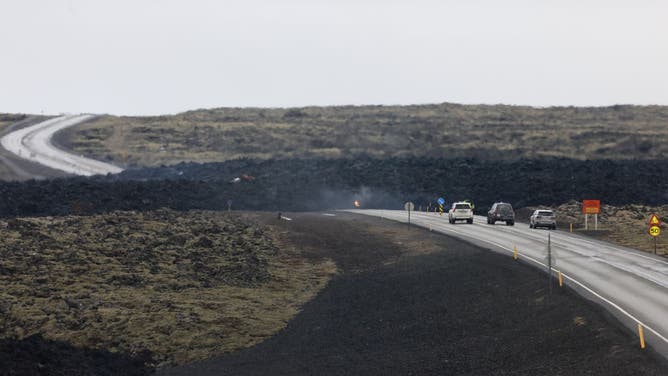 Emergency services are seen near to the site of the volcanic eruption on March 17, 2024 in Grindavik, Iceland. The Icelandic Meteorological Office confirmed a volcanic eruption started between Stora Skogfell and Hagafell on Saturday evening, the fourth time since December. A state of emergency has been declared in and around the town of Grindavik and hundreds of holidaymakers have been evacuated from the popular Blue Lagoon spa, which lies a short distance northwest of the site of the volcano.