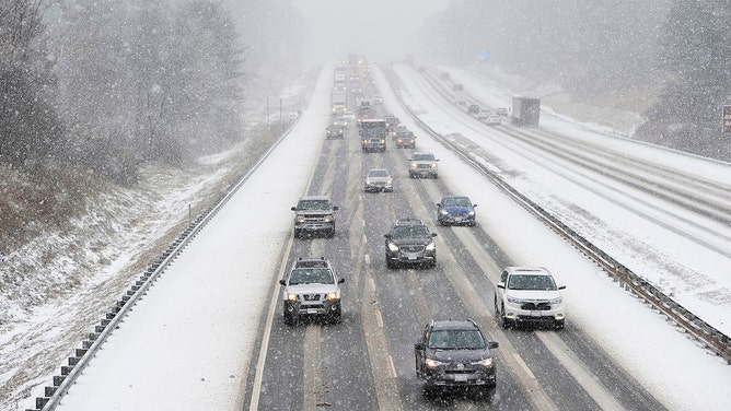 Vehicles make their way down the Maine Turnpike in Saco as the snow falls Thursday, December 29, 2016.