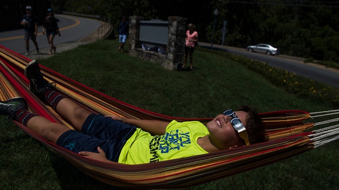 Jayce Tomcho, 10, views the solar eclipse in Sylva, N.C. on August 21, 2017.