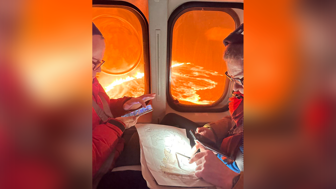 This photo shows officials on board a Icelandic Coast Guard helicopter after a volcanic eruption on Saturday, March 16, 2024.
