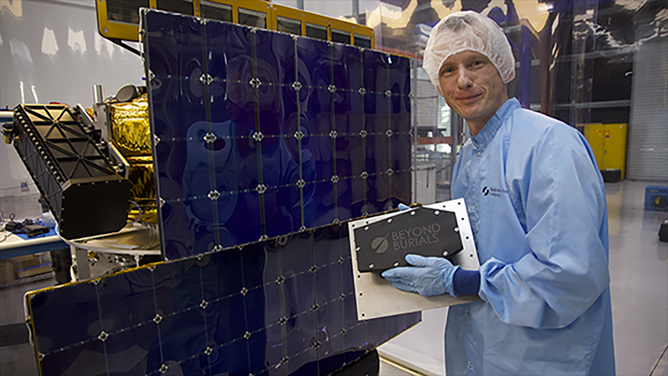 Dan Peabody, CEO of Beyond Burials, holds a payload container that was securely installed on Space Machines Company's Optimus satellite.