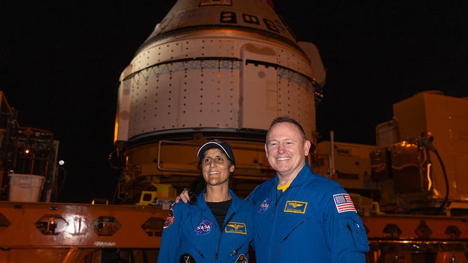 From left to right, NASA astronauts Suni Williams and Butch Wilmore pose in front of Boeing’s Starliner spacecraft in the early morning of Tuesday, April 16, 2024, outside the company’s Commercial Crew and Cargo Processing Facility at the agency’s Kennedy Space Center in Florida.