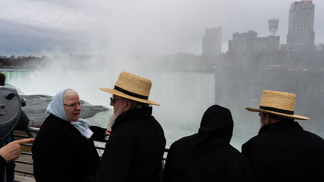 NIAGARA FALLS, NEW YORK - APRIL 8: Members of the Amish community from Lancaster County, Pennsylvania, visit Niagara Falls for the Solar Eclipse on April 8, 2024 in Niagara Falls, New York. Millions of people have flocked to areas across North America that are in the "path of totality" in order to experience a total solar eclipse. During the event, the moon will pass in between the sun and the Earth, appearing to block the sun. (Photo by Adam Gray/Getty Images)