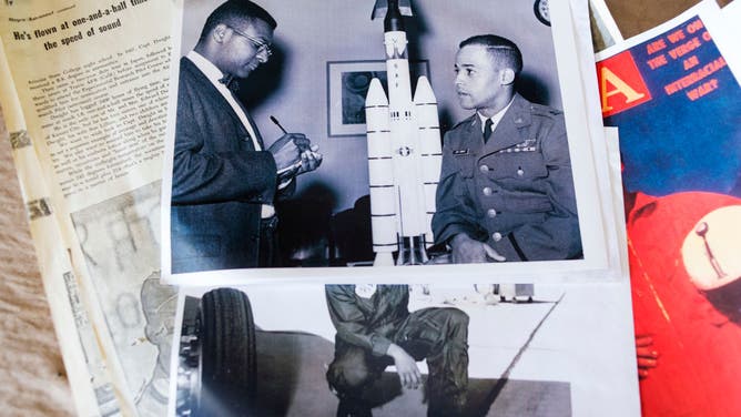 Ed Dwight, Jr. holds images and news clips that he saved from his time as an astronaut in his studio in Denver, Colorado on Thursday, June 27, 2019.