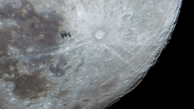 The International Space Station (ISS) is photographed with the full moon in the background from Cihanbeyli district of Konya, Turkiye on January 24, 2024.