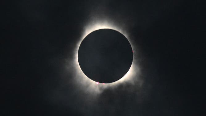 The moon eclipses the sun during a total solar eclipse across North America, at Niagara Falls State Park in Niagara Falls