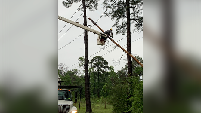 This photo shows power restoration efforts that are underway in Jasper, Texas, after severe weather tore across the region on Wednesday, April 10, 2024.