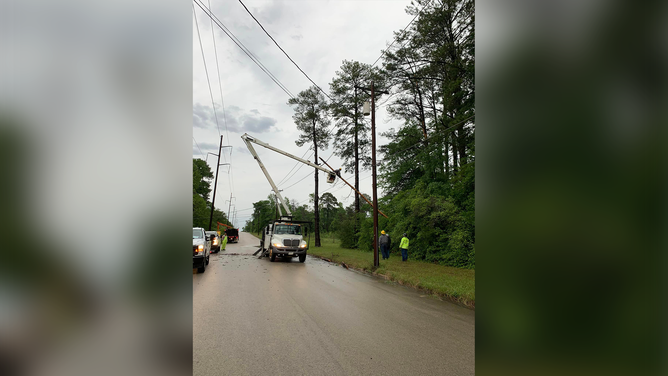 This photo shows power restoration efforts that are underway in Jasper, Texas, after severe weather tore across the region on Wednesday, April 10, 2024.