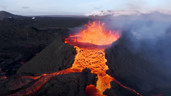 Drone footage recorded on Sunday, April 7 shows lava spewing from a volcanic crater on Iceland's Reykjanes peninsula.