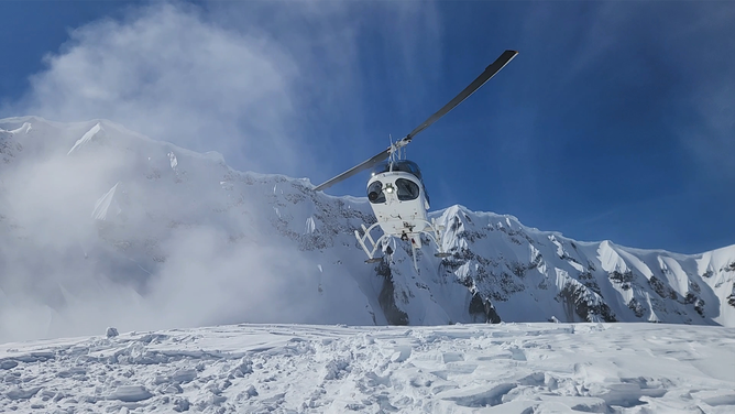A helicopter is seen in the crater of Mount St. Helens.