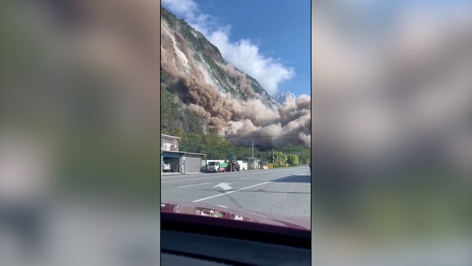 Footage by Nina Hsu shows rocks and dirt falling down a cliff onto a highway outside Hualien.