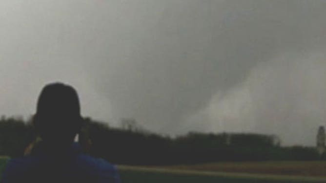 Storm chasers watch a tornado spin near West Point, Iowa, on April 16, 2024.