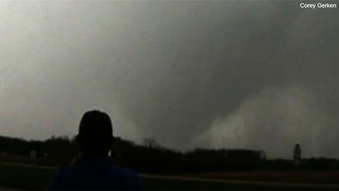 Storm chasers watch a tornado spin near West Point, Iowa, on April 16, 2024.