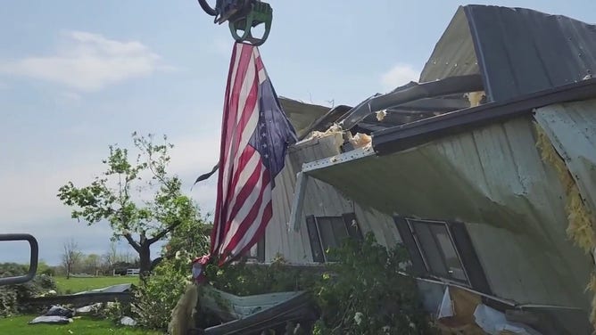 Copy TextCrews pulled an American flag from the rubble of a destroyed home in Omaha, Nebraska, on Saturday, April 27, as clean-up efforts continued in the area following a tornado.