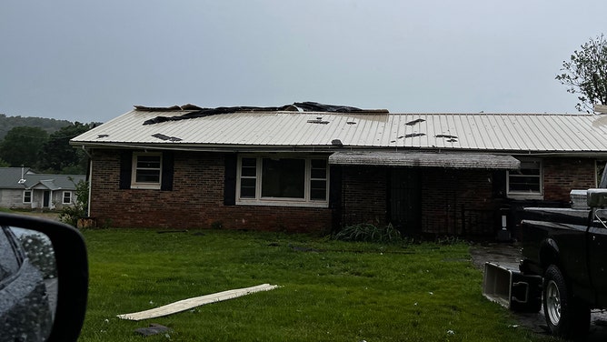 Large trees were uprooted in the vicinity of Russellville Intermediate School in Tennessee, causing roof damage to homes and the school itself, possibly due to a tornado.