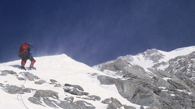 A climber stands on Windy Ridge, near the summit of Mt. McKinley in Denali National Park in Alaska.