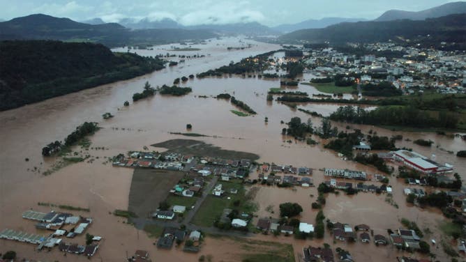 An aerial view shows flooded areas in Encantado city, Rio Grande do Sul, Brazil, on May 1, 2024. At least 10 people have died in floods caused by torrential rains in Brazil's south, authorities said on May 1, as rescuers searched for nearly two dozen individuals reported missing. (Photo by Gustavo Ghisleni / AFP) (Photo by GUSTAVO GHISLENI/AFP via Getty Images)