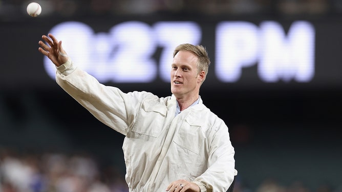 Beekeeper Matt Hilton throws out the ceremonial first pitch during a delay to the MLB game between the Los Angeles Dodgers and the Arizona Diamondbacks at Chase Field on April 30, 2024 in Phoenix, Arizona.