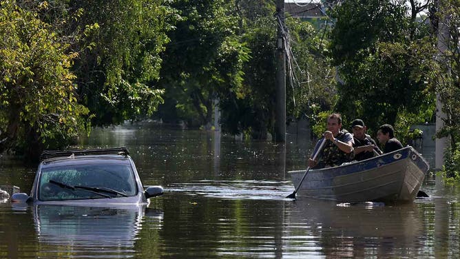Locals move in boats following floodings due to heavy rains in Porto Alegre, Rio Grande do Sul state, Brazil on May 6, 2024.