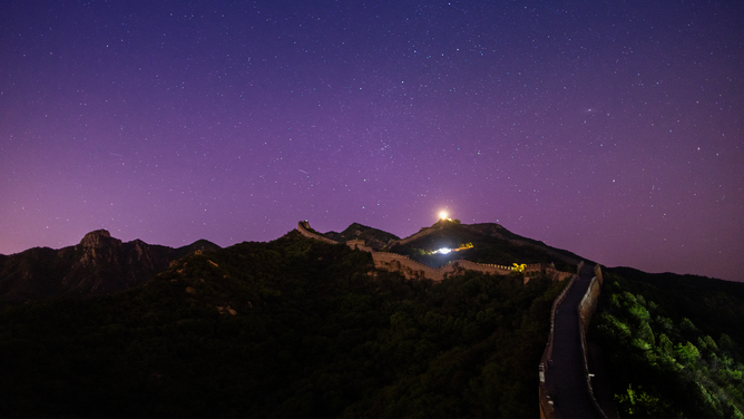 BEIJING, CHINA - MAY 12: The aurora borealis glows in the night sky over the Badaling section of the Great Wall on May 12, 2024 in Beijing, China. Due to the current geomagnetic storm, aurora borealis were observed across China on the night of May 11 and on the early morning of May 12. (Photo by Yang Dong/VCG via Getty Images)