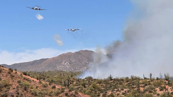 This photo shows airplanes flying over the Wildcat Fire outside Phoenix in Tonto National Forest.
