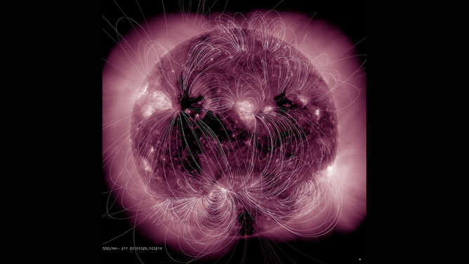 The illustration maps the magnetic field lines emanating from the Sun and their interactions superimposed on an extreme ultraviolet image taken by NASA's SDO spacecraft in 2010.