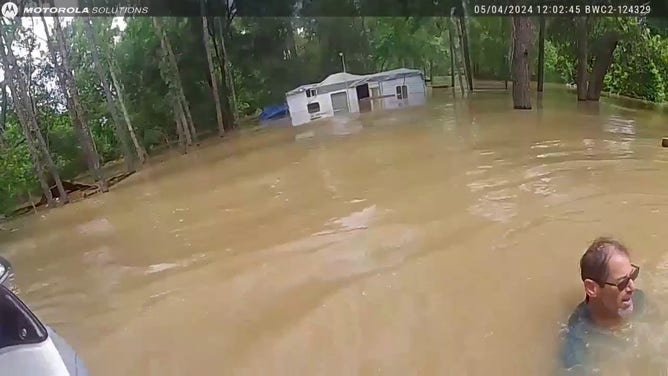 This image is from a video showing the rescue of a man and three dogs from flooding in Houston on Saturday, May 4, 2024.