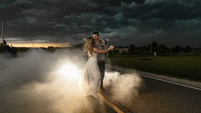 Newlyweds Trapper and MaKayla Shore took epic wedding photos as a thunderstorm approached.