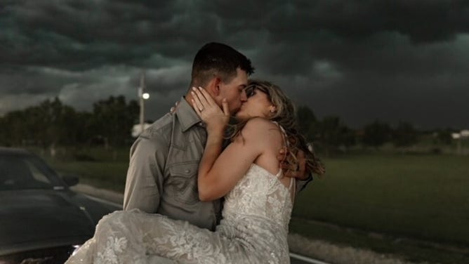 Newlyweds Trapper and MaKayla Shore took epic wedding photos as a thunderstorm approached.