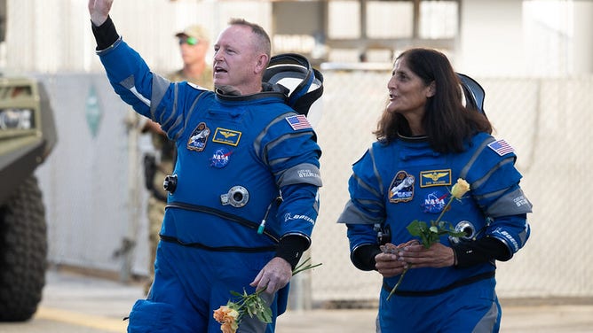 NASA astronauts Butch Wilmore, left, and Suni Williams, wearing Boeing spacesuits, are seen as they prepare to depart the Neil A. Armstrong Operations and Checkout Building for Launch Complex 41 on Cape Canaveral Space Force Station to board the Boeing CST-100 Starliner spacecraft for the Crew Flight Test launch, Wednesday, June 5, 2024, at NASA’s Kennedy Space Center in Florida.