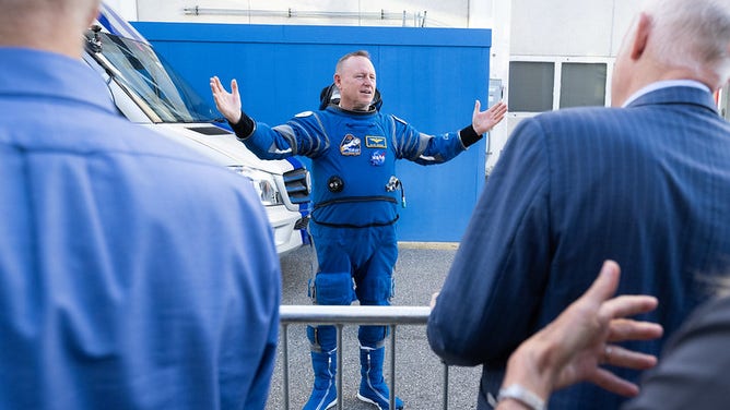 NASA astronaut Butch Wilmore, wearing a Boeing spacesuit, speaks with NASA, Boeing, and ULA leadership as he prepares to depart the Neil A. Armstrong Operations and Checkout Building with fellow crewmate NASA astronaut Suni Williams for Launch Complex 41 on Cape Canaveral Space Force Station to board the Boeing CST-100 Starliner spacecraft for the Crew Flight Test launch, Wednesday, June 5, 2024, at NASA’s Kennedy Space Center in Florida.