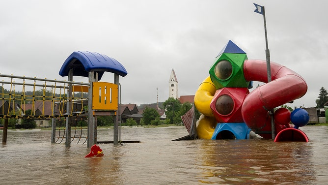 A playground is flooded by the Haselbach stream. After the heavy rainfall of the last few days, there is flooding in the region.