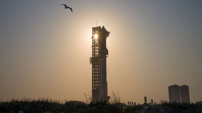 The sun sets behind the SpaceX Starship ahead of its fourth flight test at Boca Chica beach on June 05, 2024 in Brownsville, Texas