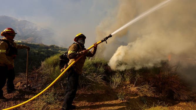 Firefighters operate at a site of the Post Fire in Gorman, about 100 km north of Los Angeles, California, the United States on June 16, 2024.