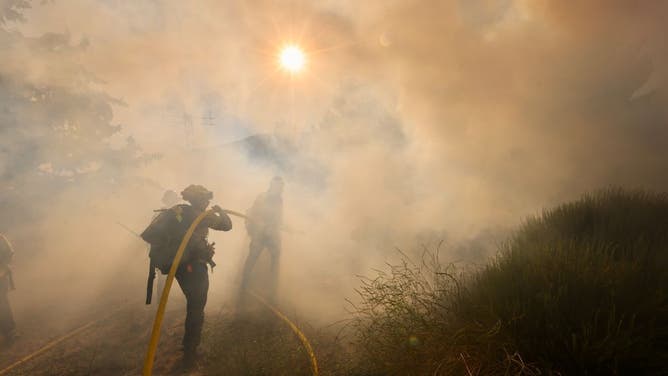 Firefighters operate at a site of the Post Fire in Gorman, about 100 km north of Los Angeles, California on June 16, 2024.
