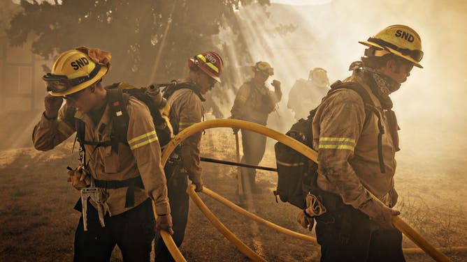 On Orwin road fire crews battle a hot spot at the Gorman Brush Fire in northern Los Angeles County on Sunday, June 16, 2024 in Gorman, CA.