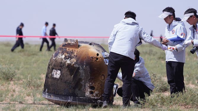 Officials prepare to recover the landing module of the Chang'e-6 moon probe after it landed in Inner Mongolia, in northern China on June 25, 2024.