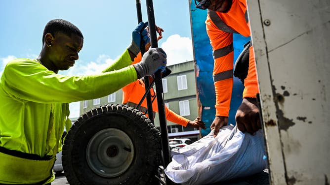Workers load sandbags into a truck in preparation for the arrival of Hurricane Beryl in Bridgetown, Barbados on June 30, 2024.