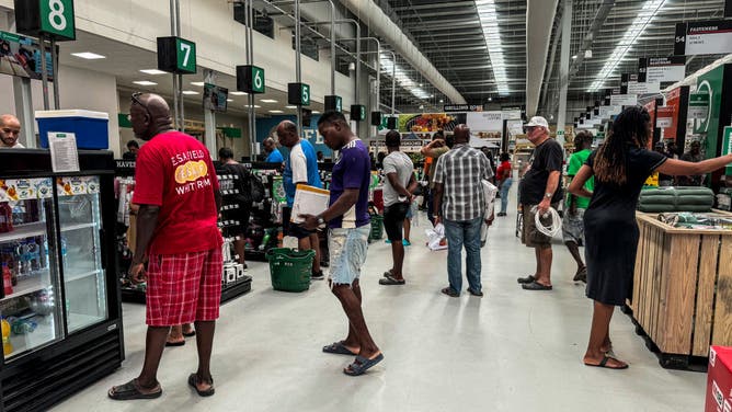People stand in line at a hardware store as they prepare for the arrival of Hurricane Beryl in Bridgetown, Barbados on June 30, 2024.